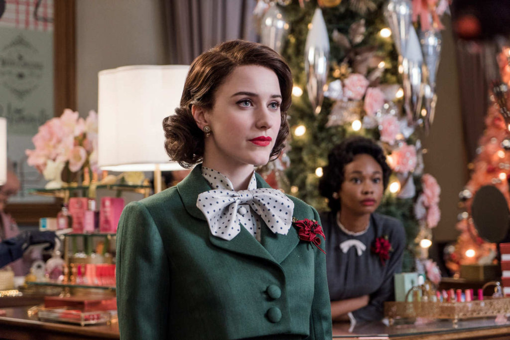 Marvelous Mrs Maisel Wearing Green Cropped Jacket and White and Blue Polka Dot Shirt and Oversized Bow Tie and Red floral pendant