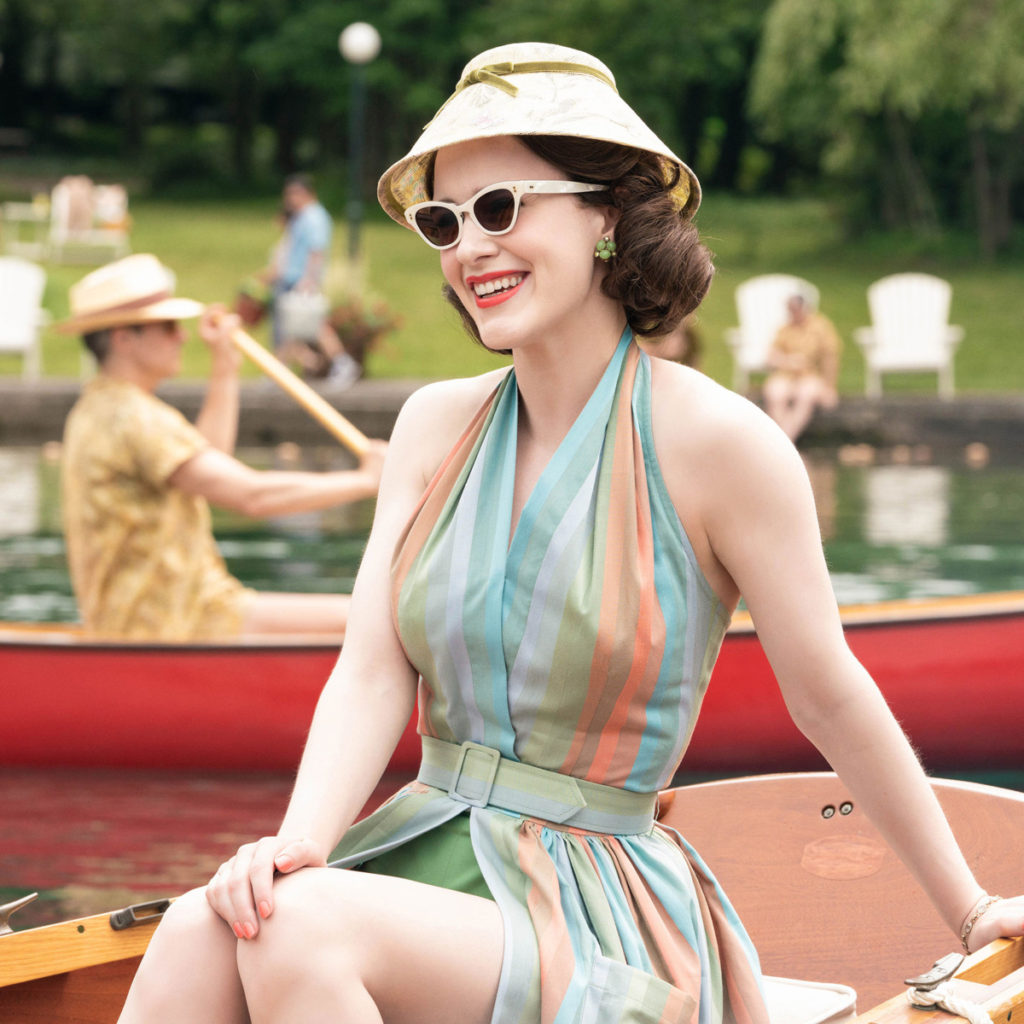 Mrs Maisel in a Canoe Wearing a Sexy Sleeveless Striped Summer Dress White Sunglasses and Straw Hatjpg