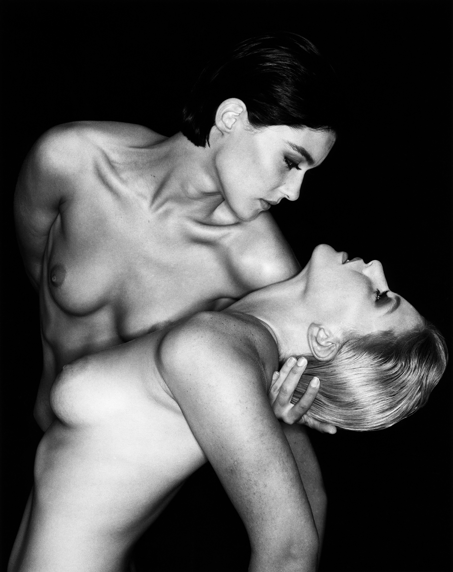 two nude women posing together