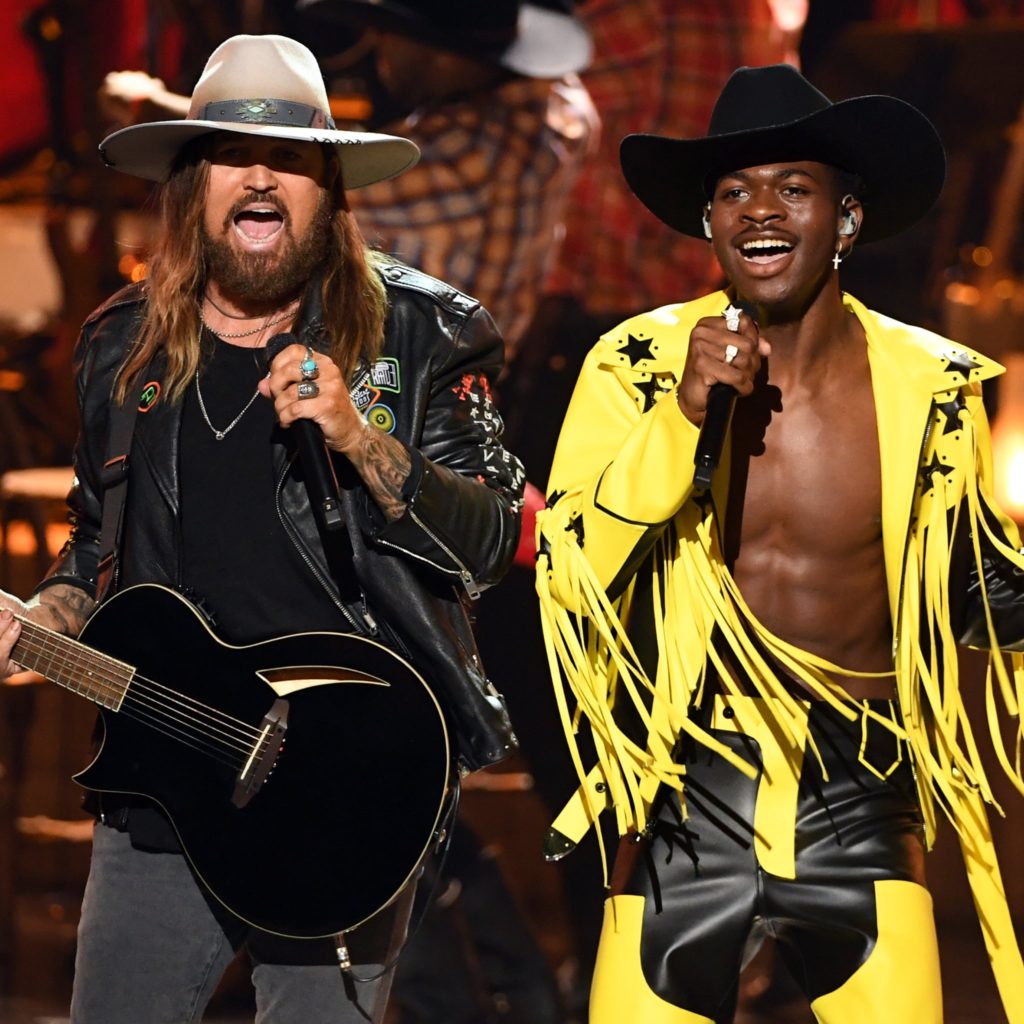 Lil-Nas-wearing black cowboy hat and yellow and black leather fringe jacket and X-Billy-Ray-Cyrus-BET-Awards-Performance-Summer 2019