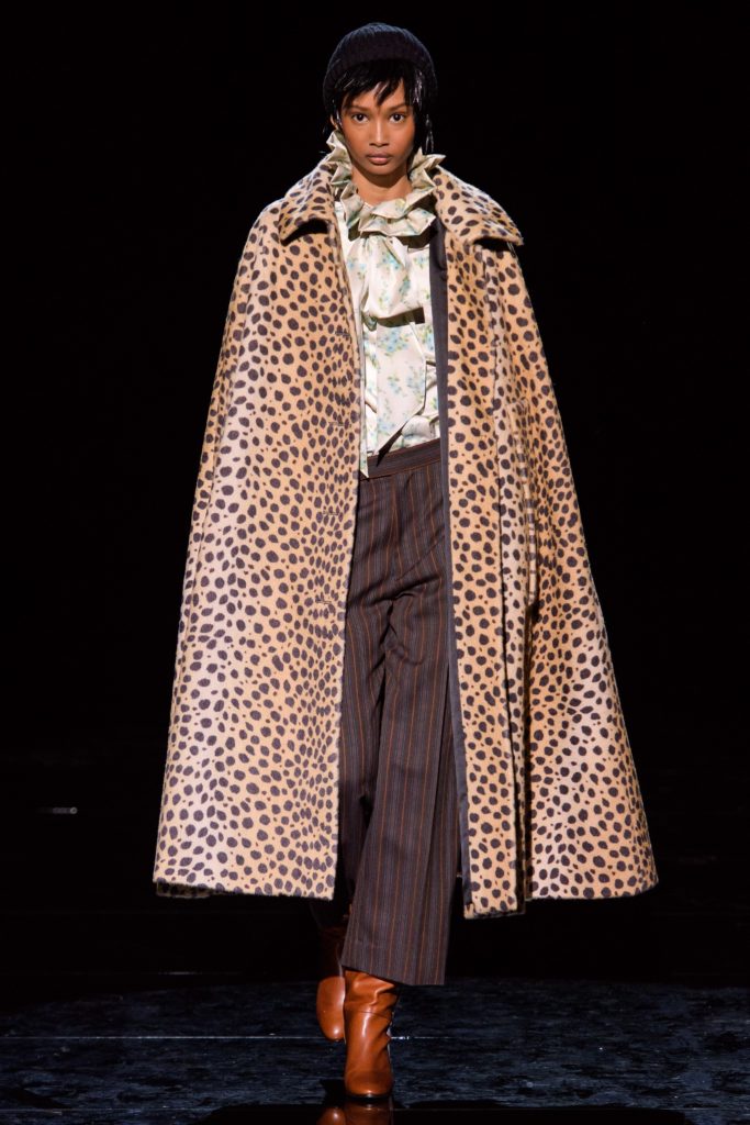 MARC JACOBS Fall 2019 Runway Model wearing Leopard Print Cape with striped pants and brown boots