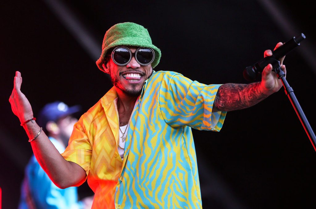 anderson-paak-live-boston-wearing yellow and light blue zebra pattern shirt-green terry cloth hat and oversized black round studded sunglasses-summer 2019