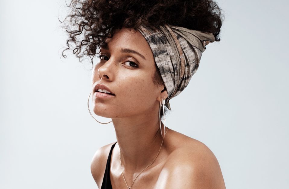 Alicia Keys looking sexy wearing a black tank-big hoops and head wrap