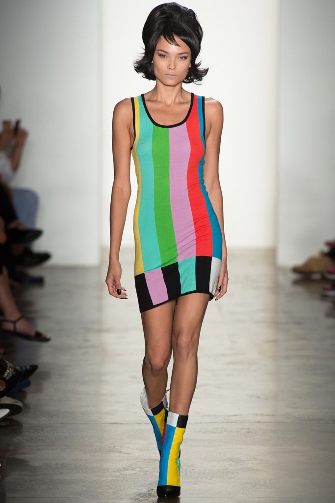 Jeremy Scott Runway SS 2020 Model with mod haircut and 1960s inspired stiped mini tank dress and matching boots
