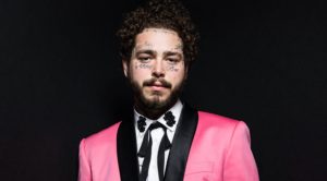 Post Malone in Pink Tuxedo with Black lapels-white shirt and skinny black cowboy tie