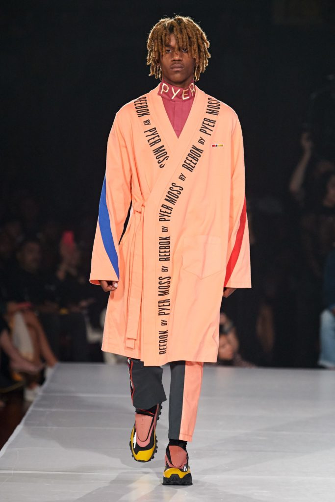 Pryer Moss Runway SS 2020 Model wearing dreds and orange robe printed with Pyer Moss by Reebok