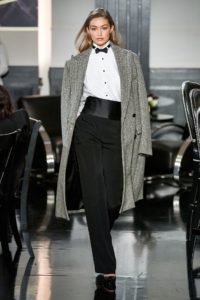 Model Gigi Hadid in Ralph Lauren Runway NY Fashion Week 2019 Wearing Sequined Tweed Black and White Coat-Tuxedo Shirt- Bow Tie-Cumberband and Black Pants
