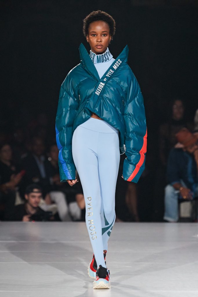Reebok by Pyer Moss Runway SS 2020 Model wearing Acqua Puffer Jacket and Light Blue Turtleneck and Leggings