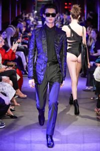 Tom Ford Runway SS 2020 Male Model Wearing A Robin Blue and Black Zebra Printed Jacket and Female Model Walking the opposite way wearing a black thong showing her butt cheeks