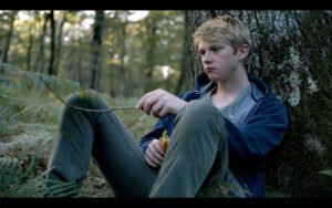 Gabriel sitting in the woods