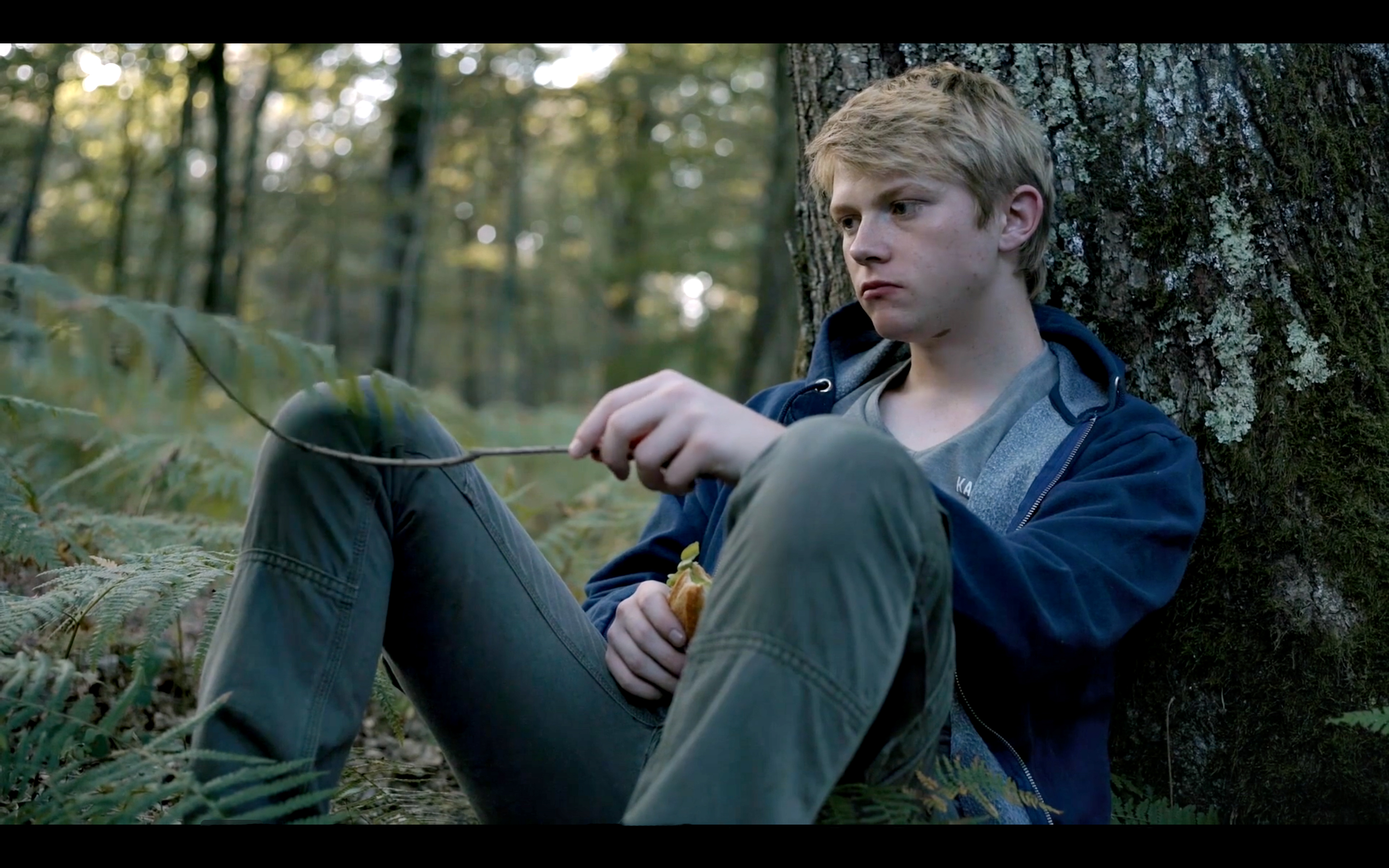 Gabriel sitting in the woods