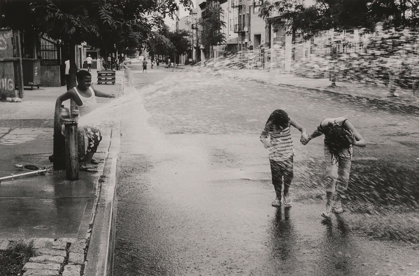 Robert Gerhardt Children Playing in the Spray from a Fire Hydrant, Myrtle Avenue, Bushwick, Brooklyn, 2010