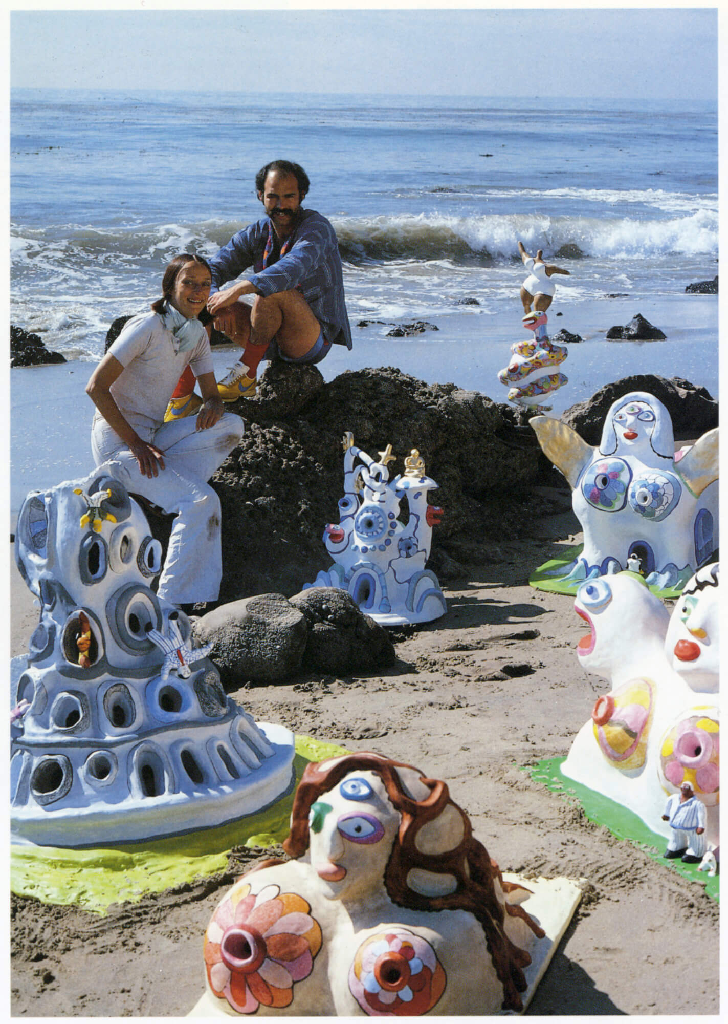 Niki de Saint Phalle with Ricardo Menon, surrounded by models of monumental projects, Malibu, California, 1979. Photo: Ronnie Kaufman.