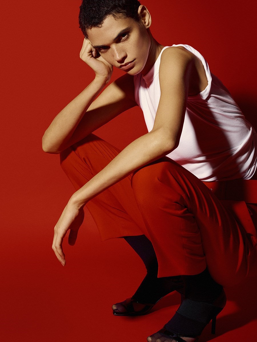 Model-Kerolyn-Soares-in-White-T-Shirt-against-a-red-background