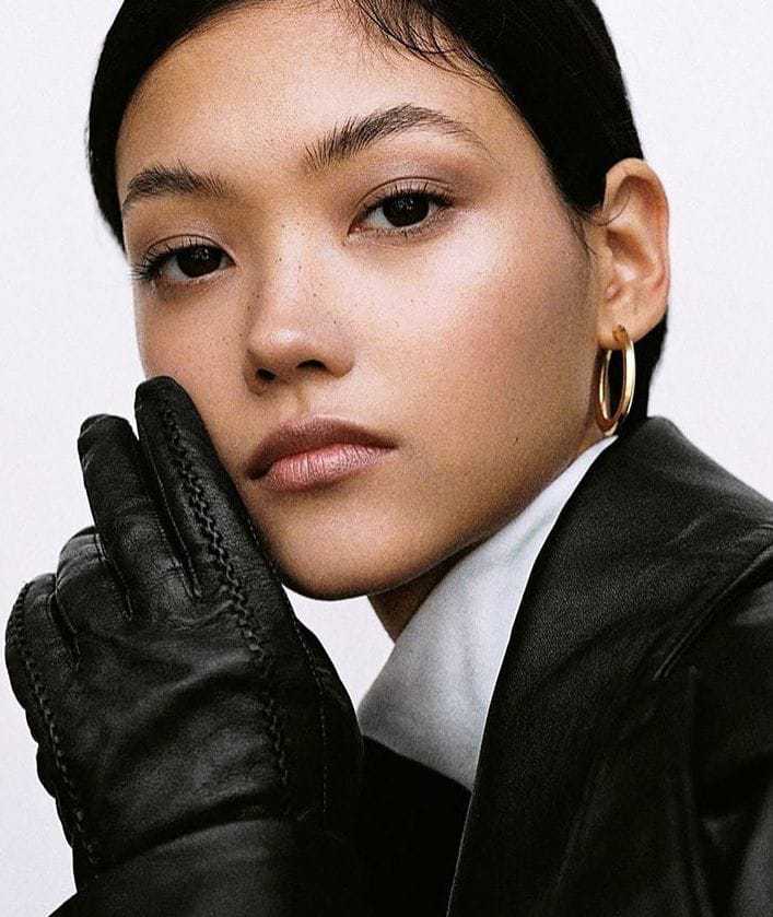 Model-Mika-Schneider-Gloved-Hand-Touching-her-face