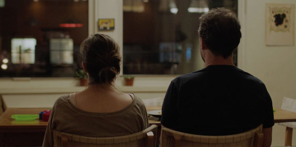 The-Neighbors Window On-Set Shot of the back of Alli and Jacob