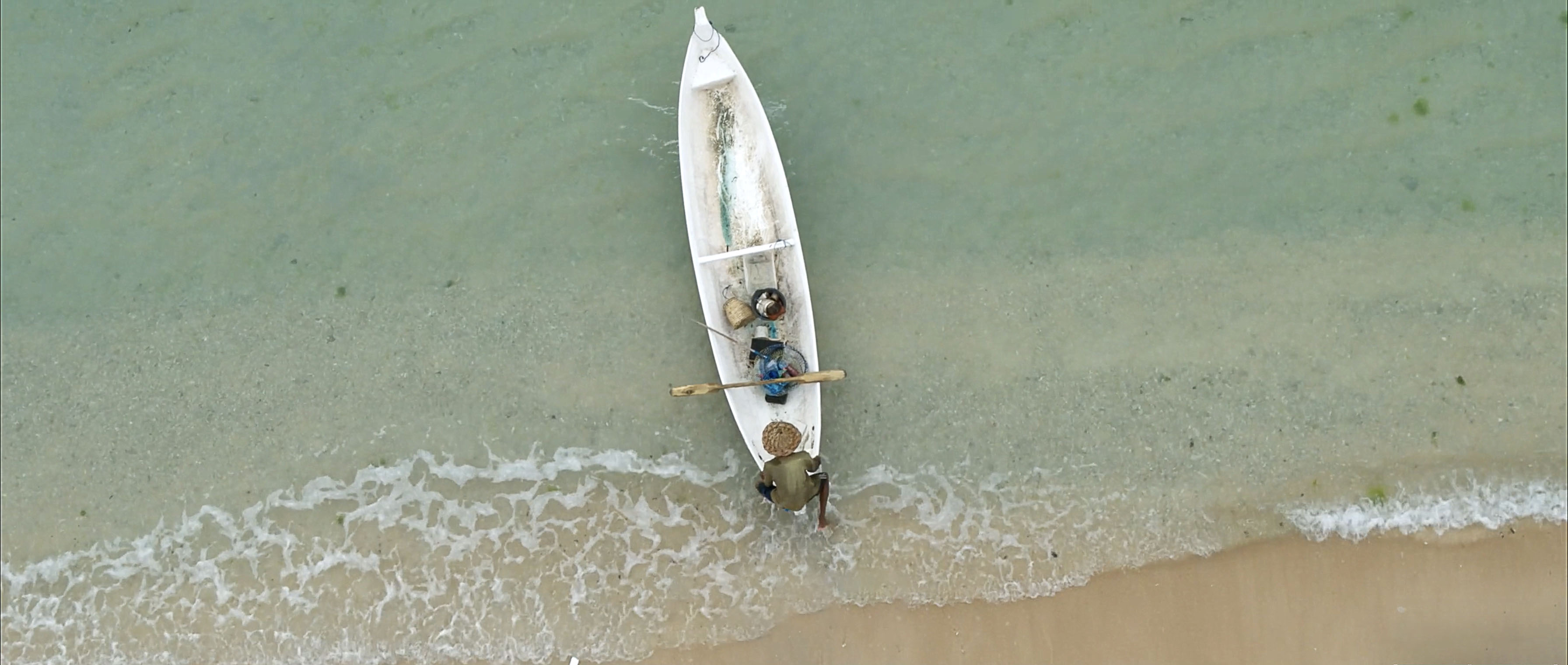 Voice-Above-Water-Fisherman-Pushing-Boat-Into-the-Sea
