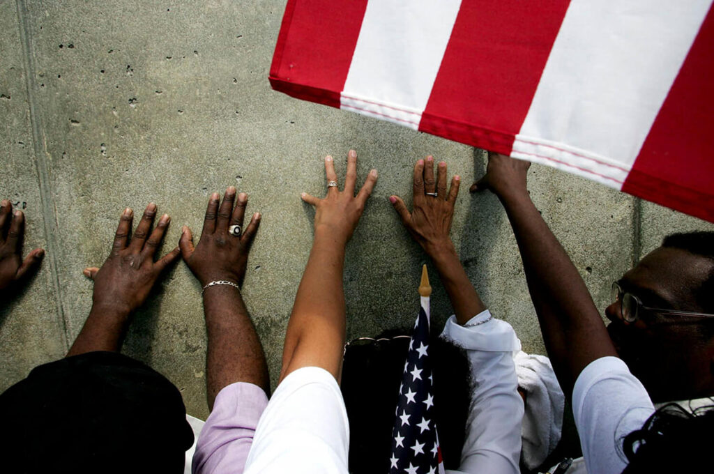 EMOTIONS RISE AT LEVEE WALL: On the Memorial Day holiday scores of people came to the Industrial Canal's Levee in New Orleans to remember the people who died here when Hurricane Katrina's arrival caused it to breech, May 5, 2005 Shot By Ozier Mohammad