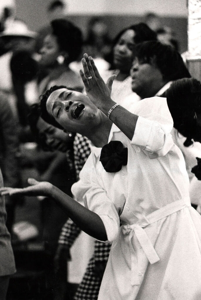 THE SPIRIT OF GOSPEL: Can't help but ride the spirit: An usher at the United House of Prayer surrenders to the sound of the gospel in Harlem, New York, 1994 Shot By Ozier Mohammad