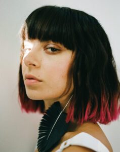 CHARLI XCX side profile with light shining on her left eye