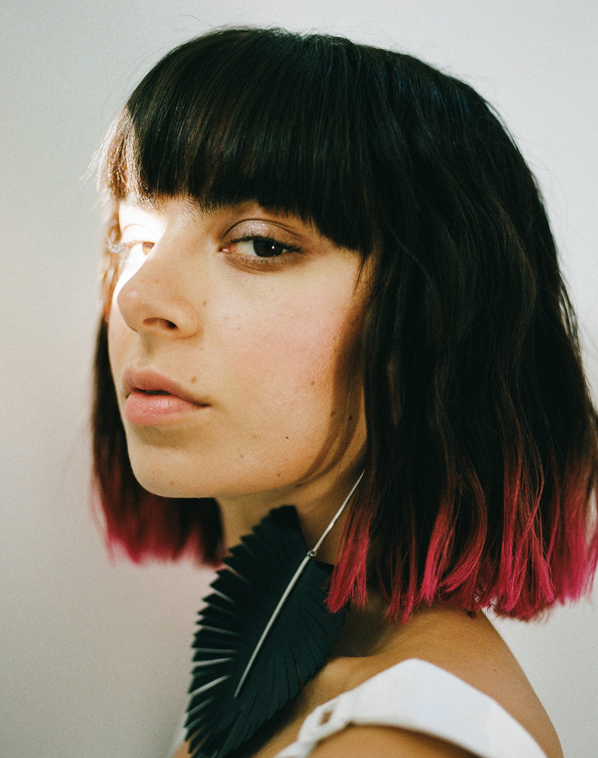 CHARLI XCX side profile with light shining on her left eye