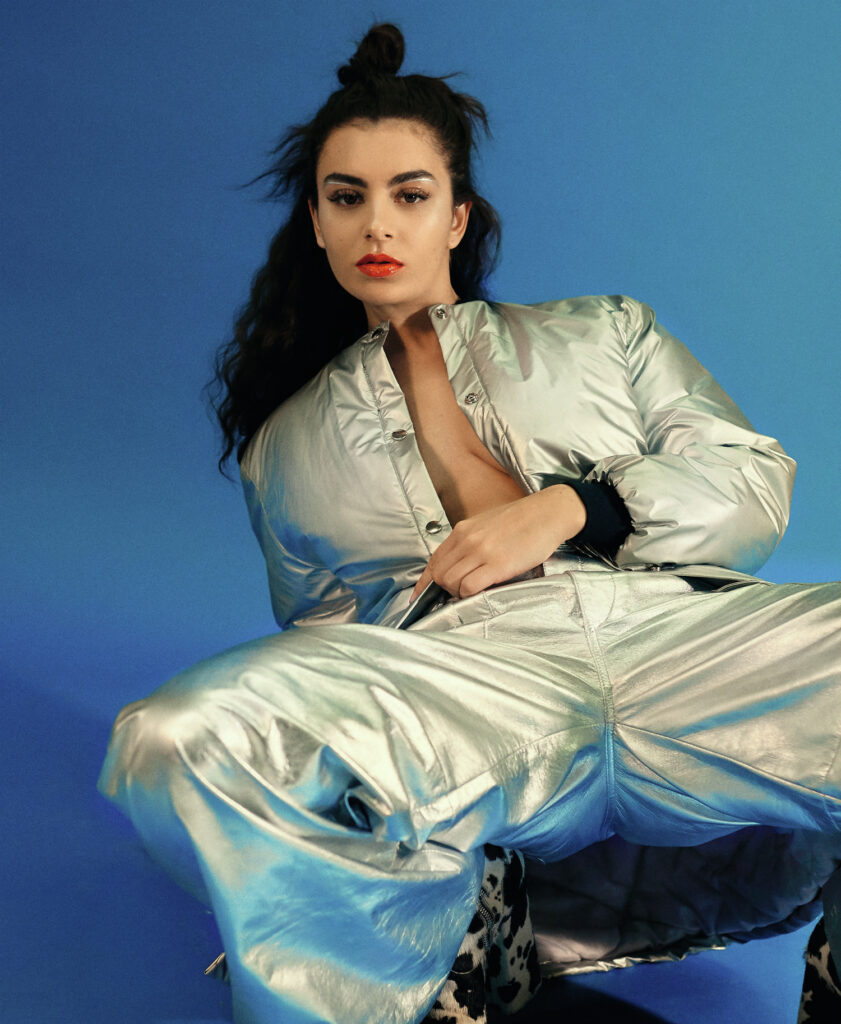 Charli XCX in unbuttoned gray jacket