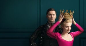 Nicholas Hout and Elle Fanning wearing pink and crown in the Great Season 2