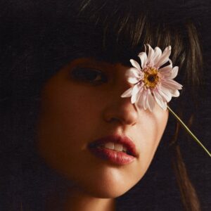 Rozzi holding a flower covering her left eye