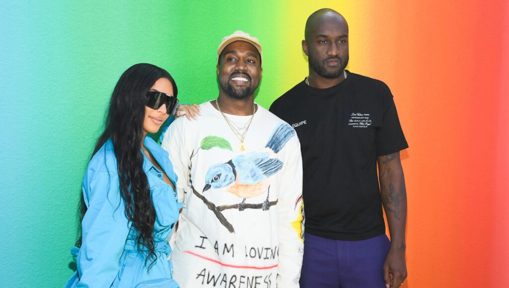 VIRGIL ABLOH_KANYE_KIM KARDASHIAN_AGAINST A GREEN YELLO AND ORANGE BACKGROUND