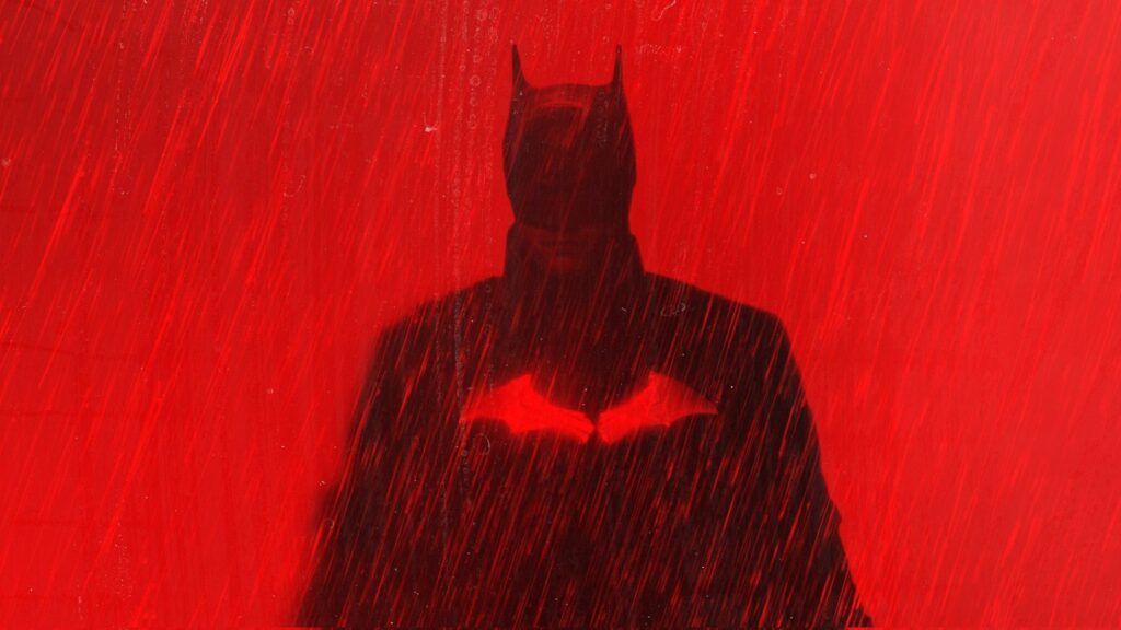 batman robert pattinson against a red background