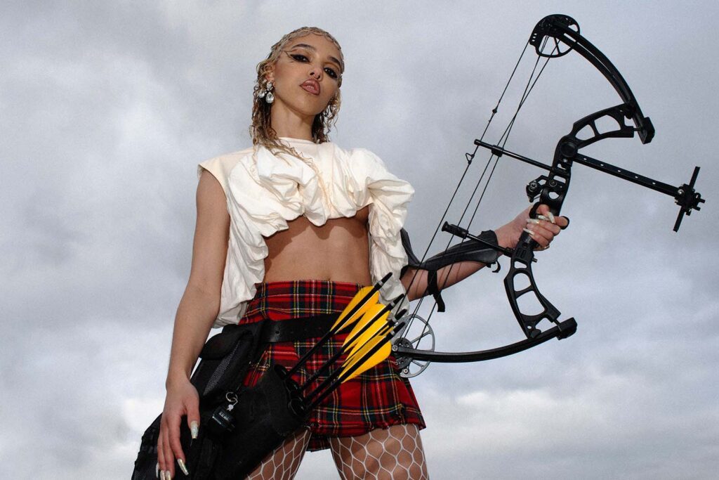 Fka-Twigs Holding Fierce Bow and Set of Arrows