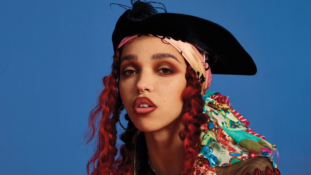 Fka-Twigs Wearing Red Dreds and black pirate inspired hat