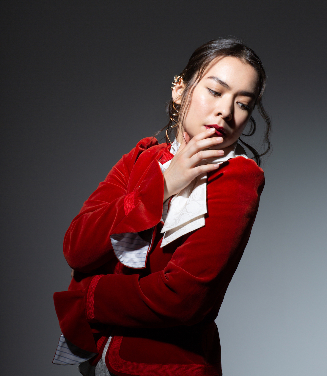 Mitski in Red Velvet Jacket Lookin to her side
