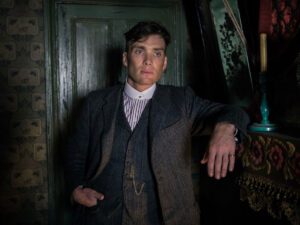 Peaky Blinders Starring Cillian Murphy as Tommy Shelby_against_a_green_door