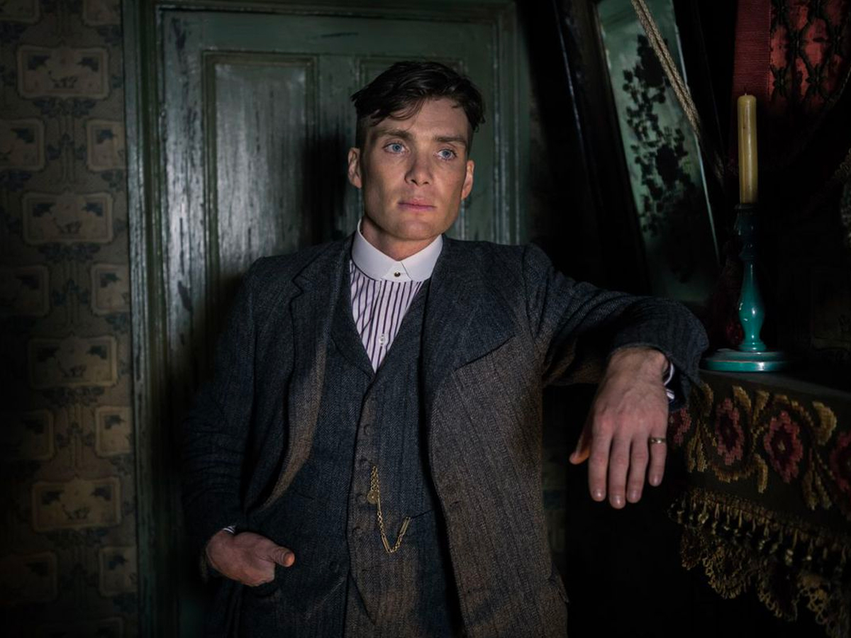 Peaky Blinders Starring Cillian Murphy as Tommy Shelby_against_a_green_door