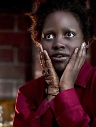 Lupita Nyongo with hands on her face in Us